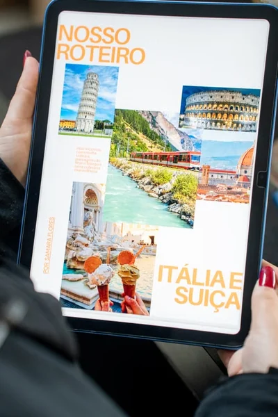 Person holding a tablet displaying a digital travel itinerary