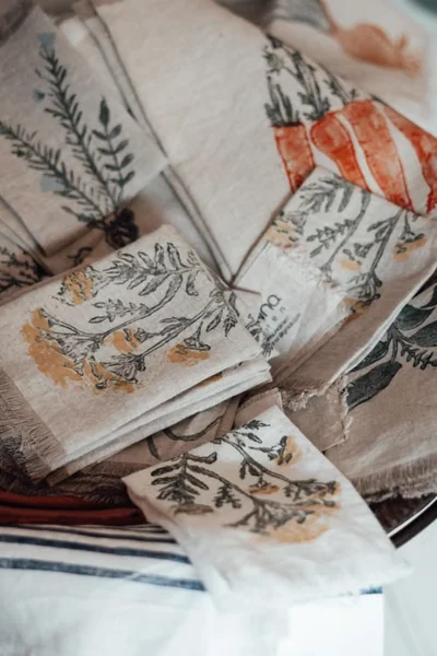Stack of patterned cloth napkins with botanical designs