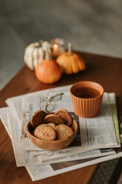 Pumpkin cookies with a cup of tea on a table