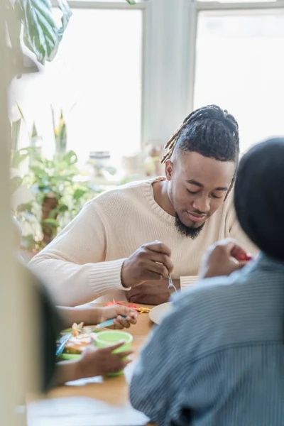 Two adults sharing a relaxed meal together at home