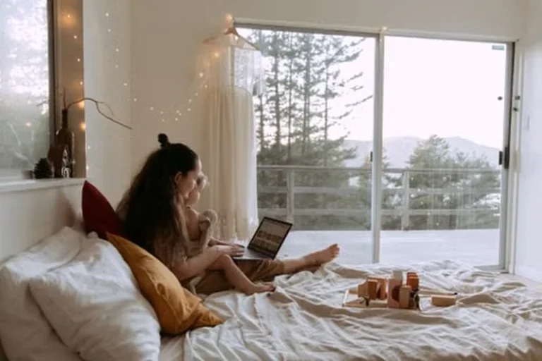 • Woman relaxing in bed with a book on a quiet Sunday morning