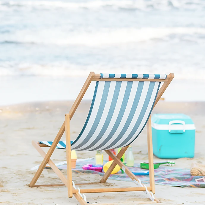 beach chair in the sand with cooler