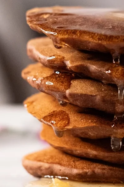Stack of pumpkin pancakes drizzled with syrup