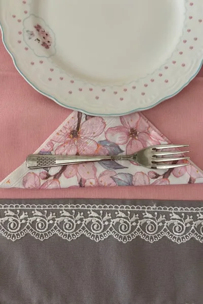 Vintage plate place setting with floral napkin and silverware