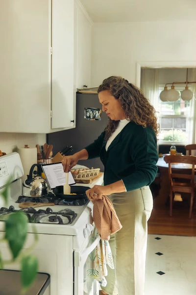 Woman cooking a meal at home in a bright kitchen